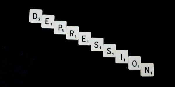 Depression, spelled out in white scrabble tiles.